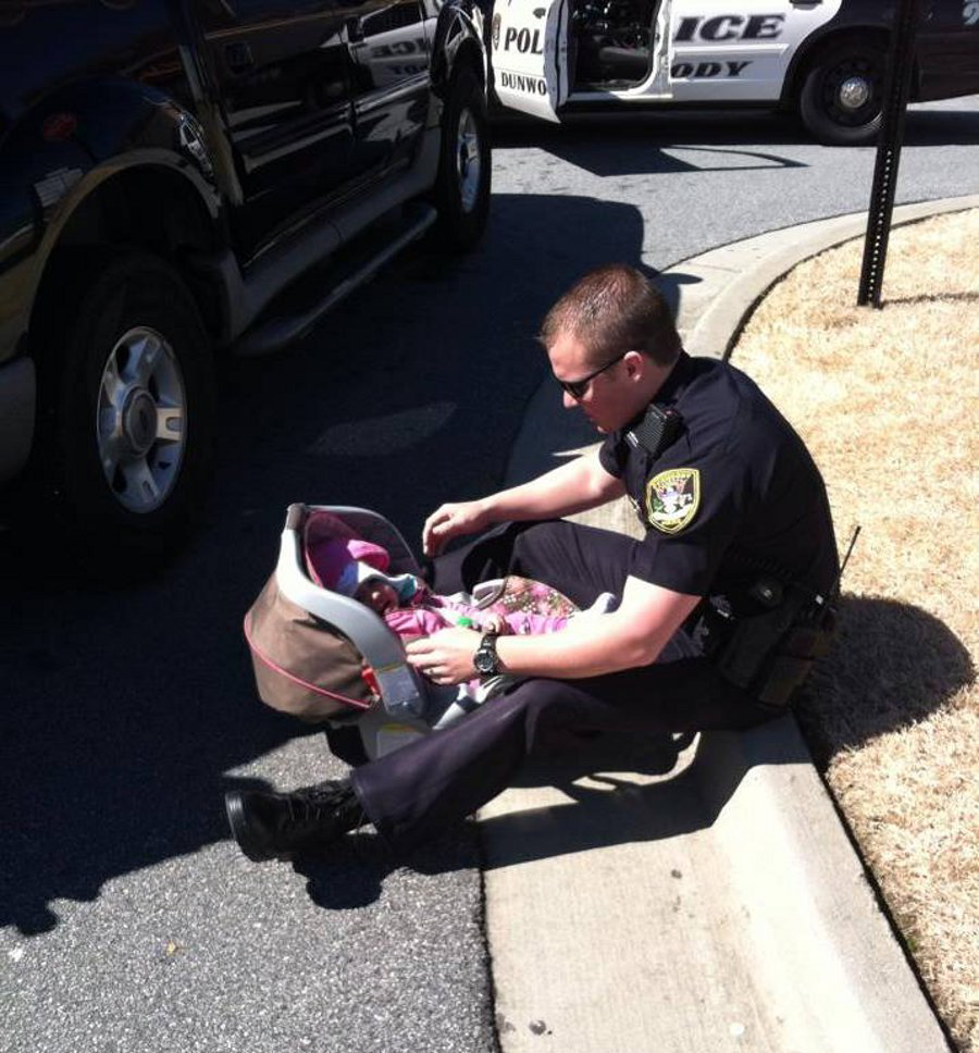 A photo of Dunwoody Officer Kerry Stallings with a baby was taken by another officer and was posted on Facebook where it went viral.