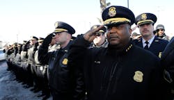 Members of the Detroit Police Dept. salute after the funeral for Jayvon Felton at Hartford Memorial Baptist Church in Detroit on March 3.