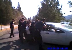 In this still taken from a Coeur d'Alene Police officers body-mounted camera, officers approach after firing approximately 77 rounds at a car driven by Christian Buquet during a pursuit in September of 2012. In this still taken from a Coeur d'Alene Police officers body-mounted camera, officers approach after firing approximately 77 rounds at a car driven by Christian Buquet during a pursuit in September of 2012.