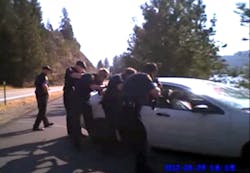 In this still taken from a Coeur d&apos;Alene Police officers body-mounted camera, officers approach after firing approximately 77 rounds at a car driven by Christian Buquet during a pursuit in September of 2012.