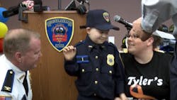 Tyler Seddon is seen as he is sworn in as honorary police chief in his hometown of Burrillville, R.I. on his seventh birthday.