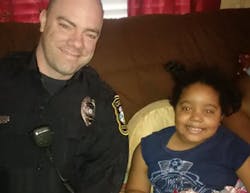 Officer Baxter Stegall is seen with 6-year-old Najah Zarif Officer Baxter Stegall is seen with 6-year-old Najah Zarif