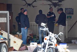 Authorities investigate a crime scene at a house in Pleasant Grove, Utah on April 13.