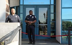 Los Angeles police officers stand outside the West Traffic Division station on April 8 after an officer was shot and wounded inside the station Monday evening.