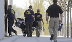 Members of the FBI evidence response team enter the Federal Courthouse on April 21 in Salt Lake City. Members of the FBI evidence response team enter the Federal Courthouse on April 21 in Salt Lake City.