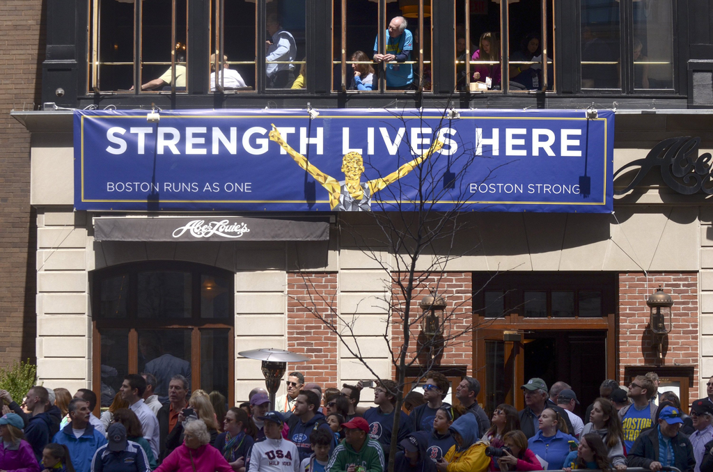 Spectators watch runners during the 118th Boston Marathon on April 21.