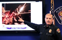 Albuquerque Police Chief Gorden Eden shows the image of a man who brought a rifle to an hours' long protest over police shootings during a news conference on March 31. Albuquerque Police Chief Gorden Eden shows the image of a man who brought a rifle to an hours' long protest over police shootings during a news conference on March 31.