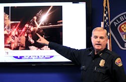 Albuquerque Police Chief Gorden Eden shows the image of a man who brought a rifle to an hours&apos; long protest over police shootings during a news conference on March 31.