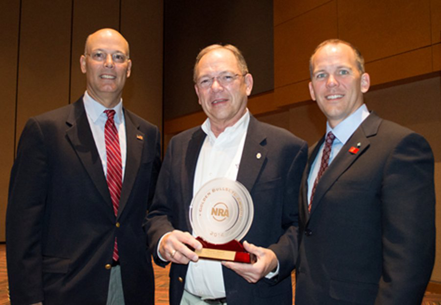 Photo Caption: Frank Brownell (center) is congratulated by Doug Hamlin, Executive Director, NRA Publications (left) and Pete Brownell (right)