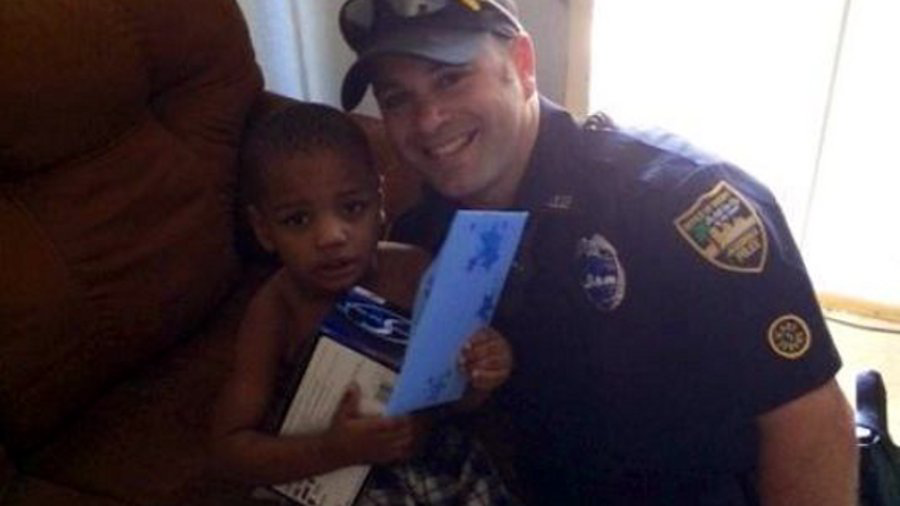 Officer Derek Pratico is seen with the young boy.