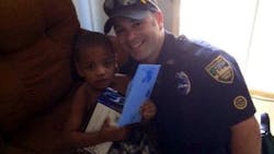 Officer Derek Pratico is seen with the young boy. Officer Derek Pratico is seen with the young boy.