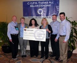 Streamlight representatives present a check to C.O.P.S. Executive Director Dianne Bernhard (second from left) and Madeline Neumann, National President (fourth from left) during National Police Week, May 11-17.
