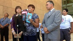 Jose Antonio Elena Rodriguez&apos;s grandmother, Taide Elena, displays pictures of her grandson at a news conference on July 29.