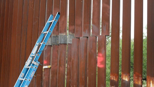A repair crew&apos;s ladder leans against a section of the border fence under repair near Nogales, Ariz. on July 27.
