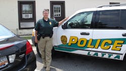 Latta Police Chief Crystal Moore stands beside her police SUV July 10. Latta Police Chief Crystal Moore stands beside her police SUV July 10.