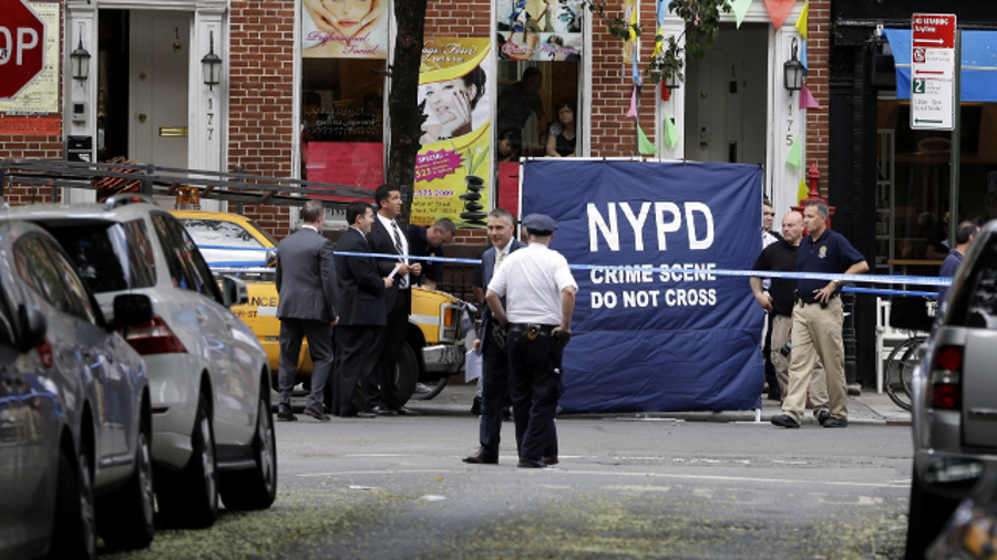 Police officers stand near a crime scene on July 28 in New York.