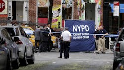 Police officers stand near a crime scene on July 28 in New York. Police officers stand near a crime scene on July 28 in New York.