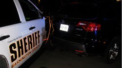 A woman was arrested early Saturday after she rammed a car, causing it to strike a sheriff&apos;s office patrol vehicle and pin a deputy.