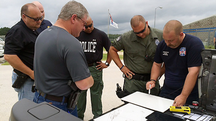 Law enforcement personnel quickly devise a way to secure the perimeter of the Diboll Correctional Facility on July 19 in Diboll, Texas.