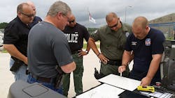 Law enforcement personnel quickly devise a way to secure the perimeter of the Diboll Correctional Facility on July 19 in Diboll, Texas.