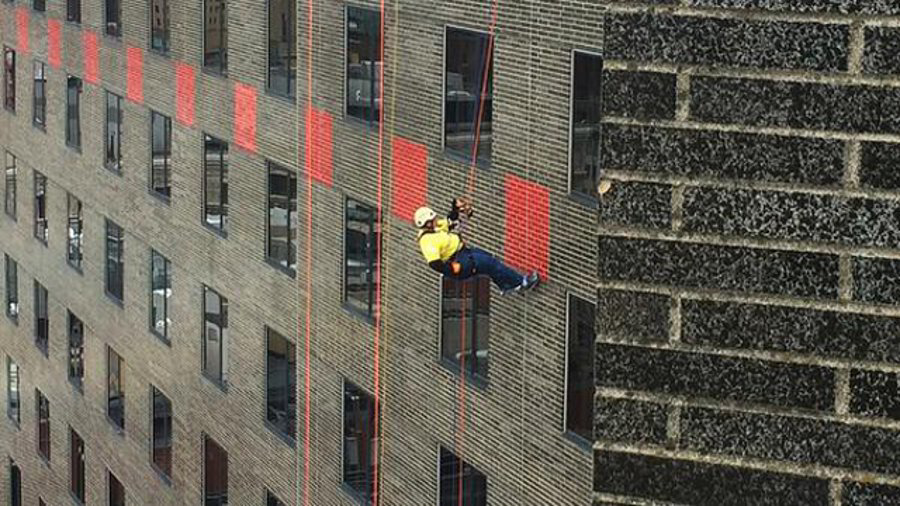 Gloucester Police Chief Leonard Campanello rappelled down the side of the 23-story Hyatt Regency Hotel Saturday as part of the Special Olympics' 'toss your boss' fundraiser.