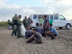 Border Patrol agents detain immigrants who crossed from Mexico into the United States near McAllen on June 27.