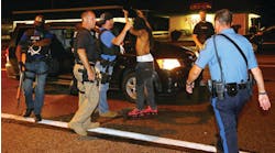 A protester is arrested while walking down the street on West Florissant Avenue on a relatively peaceful night on Aug. 20 in Ferguson, Mo.