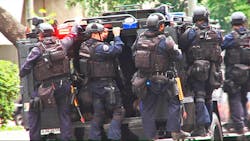Los Angeles Police Department SWAT officers ride on an armored medical rescue vehicle in a drill simulating a terrorist attack in downtown Los Angeles on July 6. Los Angeles Police Department SWAT officers ride on an armored medical rescue vehicle in a drill simulating a terrorist attack in downtown Los Angeles on July 6.