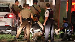 Police take cover near a QuikTrip in 9400 block of W. Florissant Avenue after shots were fired at them in Ferguson, Mo. on Aug. 11, 2014. Police take cover near a QuikTrip in 9400 block of W. Florissant Avenue after shots were fired at them in Ferguson, Mo. on Aug. 11, 2014.