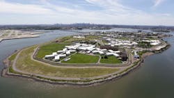 An aerial photo shows New York&apos;s biggest lockup, Riker&apos;s Island jail, with the New York skyline in the background.
