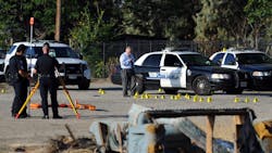 San Bernardino Police investigate the scene where a police officer shot and killed a gunman during an early morning shootout that began after another officer was gravely wounded on Aug. 22. San Bernardino Police investigate the scene where a police officer shot and killed a gunman during an early morning shootout that began after another officer was gravely wounded on Aug. 22.