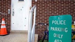 Bullet holes are seen in a door at police headquarters on Aug. 12 in West Deptford, N.J. Bullet holes are seen in a door at police headquarters on Aug. 12 in West Deptford, N.J.