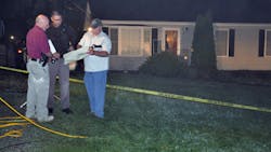 police investigate the home where a family of five, including three children, were found shot to death Sunday night, in Culpeper, Va.