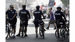 Officers on bicycles keep watch as demonstrators protesting several incidents of alleged Los Angeles Police Department brutality. Officers on bicycles keep watch as demonstrators protesting several incidents of alleged Los Angeles Police Department brutality.