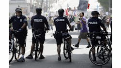 Officers on bicycles keep watch as demonstrators protesting several incidents of alleged Los Angeles Police Department brutality.