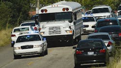 Police officers escort UPS employees on a bus from the scene where three people were killed, including the gunman, at a UPS facility in Birmingham, Ala. on Sept. 23. Police officers escort UPS employees on a bus from the scene where three people were killed, including the gunman, at a UPS facility in Birmingham, Ala. on Sept. 23.