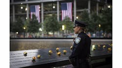 Port Authority Police Officer Donna Przybyszewski takes a moment to herself before family members are let in for the memorial observances held at the site of the World Trade Center in New York. Port Authority Police Officer Donna Przybyszewski takes a moment to herself before family members are let in for the memorial observances held at the site of the World Trade Center in New York.