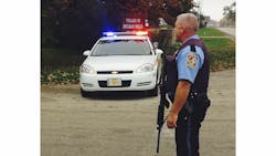 A McHenry County Sheriff&apos;s deputy blocks a street in Holiday Hills, Ill. on Oct. 16 near the site where two deputies were shot with a rifle when they responded to a domestic dispute.