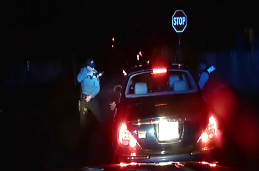 Police officers Braheme Days and Roger Worley stand near a car they pulled over for running a stop sign in Bridgeton, N.J.