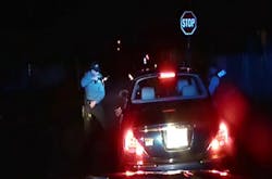 Police officers Braheme Days and Roger Worley stand near a car they pulled over for running a stop sign in Bridgeton, N.J. Police officers Braheme Days and Roger Worley stand near a car they pulled over for running a stop sign in Bridgeton, N.J.