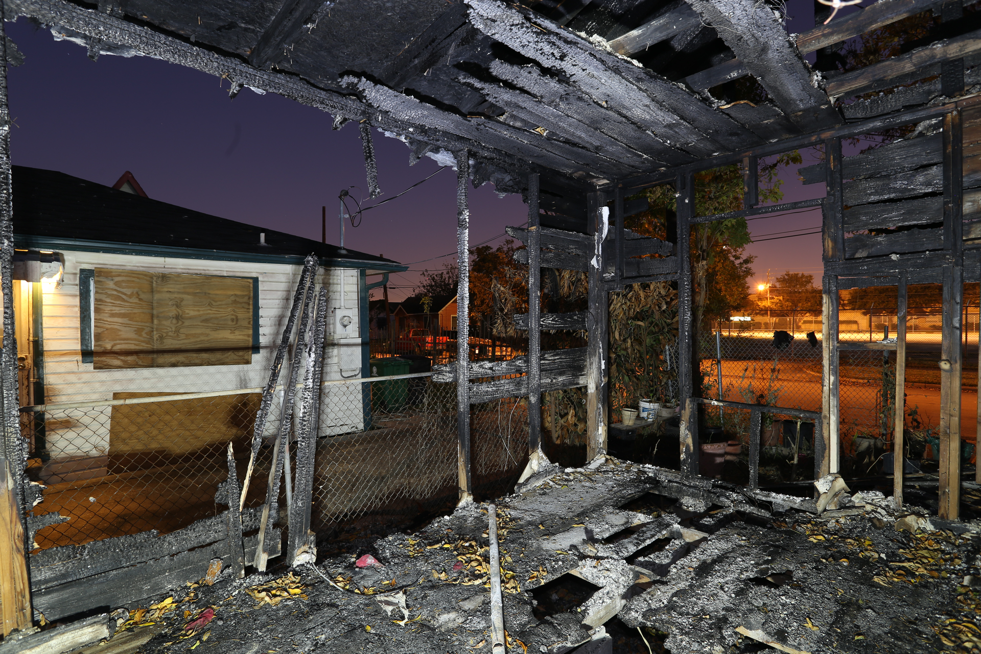 1st Place Photograph - Forensic Photography, 'Fire Fatality'by Christopher D. Duncan, Crime Scene Investigator, Houston Police Department. This photograph was recorded during a fire investigation and the image&rsquo;s exposure settings were ISO 100, f/8, and 20 seconds. During that 20 seconds, multiple flashes were cast across the scene in order to highlight the dark structure.