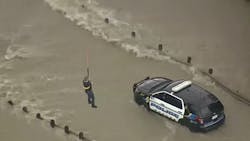 A Texas Department of Public Safety helicopter rescued a Sachse police officer who became stranded in floodwaters while stopping traffic Friday morning. A Texas Department of Public Safety helicopter rescued a Sachse police officer who became stranded in floodwaters while stopping traffic Friday morning.