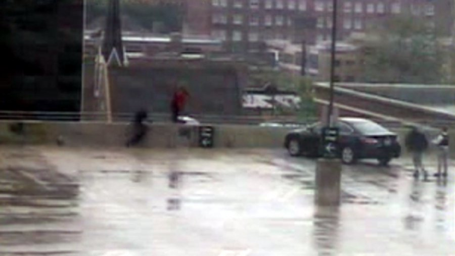 Evanston Detective Ken Carter, seen in black on the left, helps save a suicidal man from jumping off the top of a parking garage.