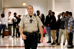 Shelby County Sheriff's Department SRO Joseph Fox wears a body camera while on duty on Oct. 15, 2014, at Southwind High School in Memphis, Tenn.
