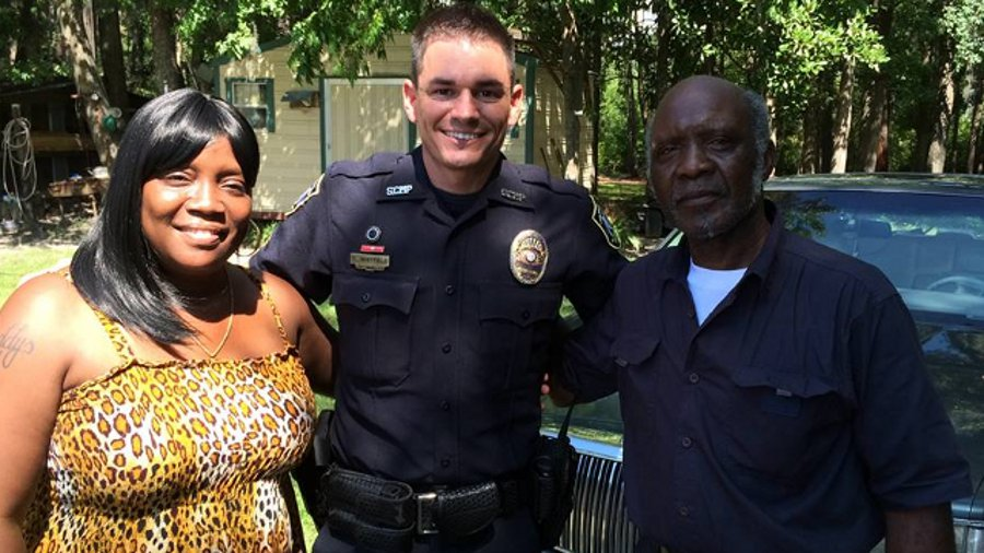 Savannah-Chatham Officer Robert Whitfield, center, went into a burning home to rescue an elderly man and his daughter.