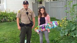 Utah County Deputy John Thomas, left, stands with Kaylie English and her new skateboard. Utah County Deputy John Thomas, left, stands with Kaylie English and her new skateboard.