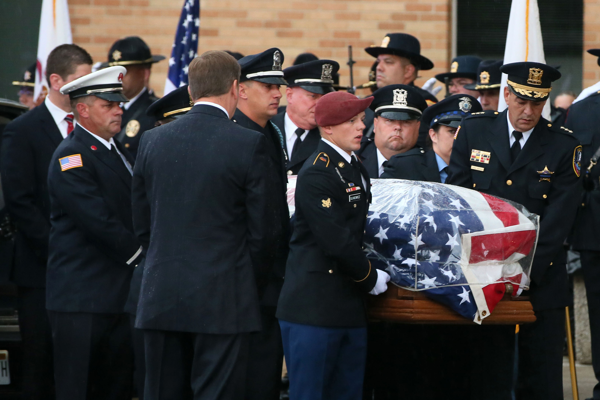Covered in an American flag, the casket of slain Fox Lake police Lt. Charles Joseph Gliniewicz arrives at Antioch Community High School on Sept. 7.