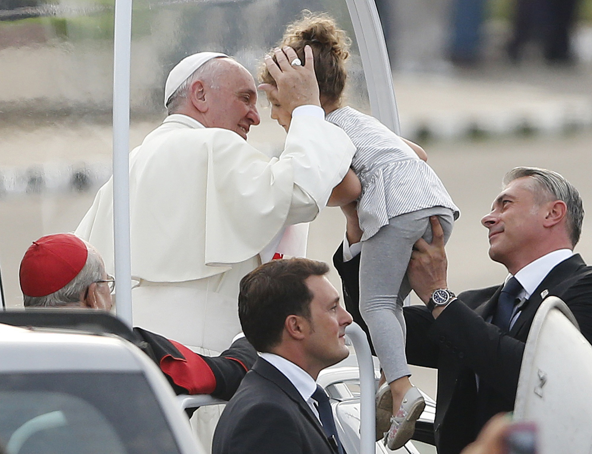 Pope Francis blesses a child as he arrives to celebrate Sunday Mass at the Plaza de la Revolucion in Havana, Cuba, on Sept. 20.