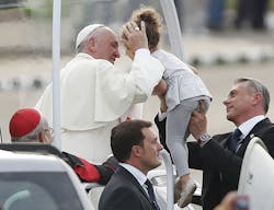 Pope Francis blesses a child as he arrives to celebrate Sunday Mass at the Plaza de la Revolucion in Havana, Cuba, on Sept. 20. Pope Francis blesses a child as he arrives to celebrate Sunday Mass at the Plaza de la Revolucion in Havana, Cuba, on Sept. 20.