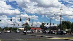 Two police officers were stopped at a stop light when a man approached their patrol car and opened fire with a semi-automatic handgun Sunday afternoon.